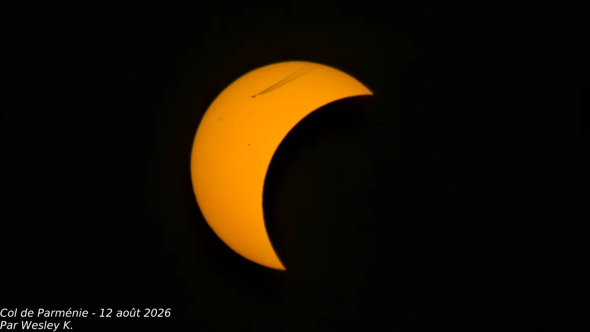 Airplane flying in front of the sun and moon